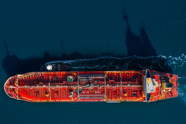 Aerial view of an oil tanker arriving at port assisted by a tug boat in New York Harbor.